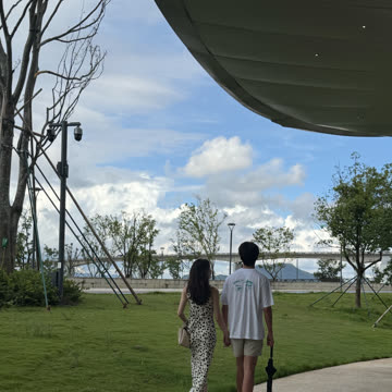 Walking hand in hand through a park